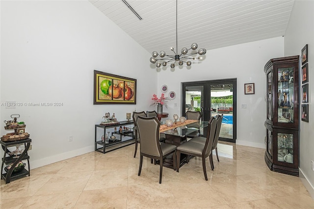 dining space with french doors, high vaulted ceiling, and a notable chandelier