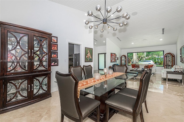 dining area featuring lofted ceiling and a chandelier