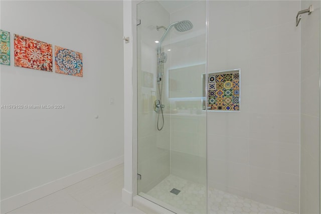 bathroom with tile patterned flooring and tiled shower