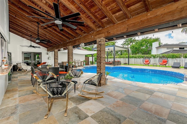 view of pool featuring ceiling fan and a patio