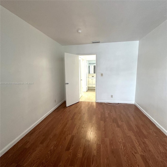 spare room featuring dark hardwood / wood-style flooring