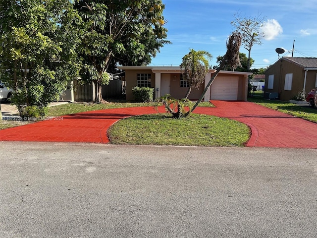 view of front facade featuring a garage and a front lawn