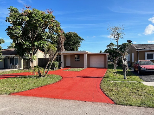 view of front of house with a garage and a front yard