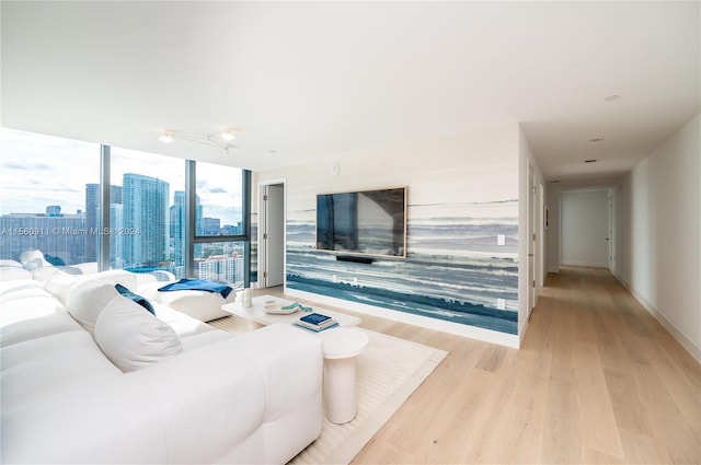 living room with floor to ceiling windows and light wood-type flooring