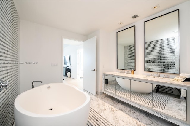 bathroom featuring double sink, tile floors, and a tub