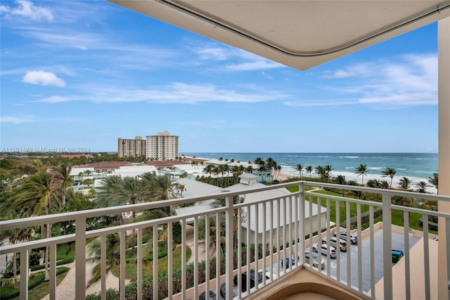 balcony featuring a beach view and a water view