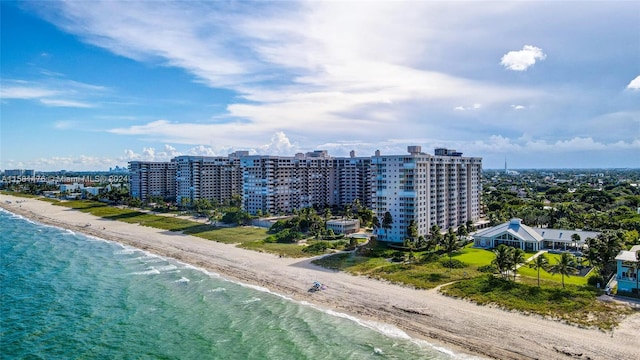 drone / aerial view featuring a beach view and a water view