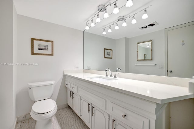 bathroom featuring vanity, toilet, and tile patterned floors