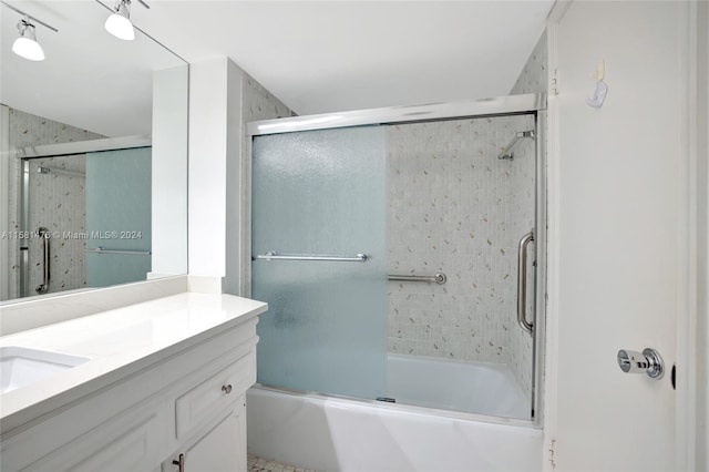 bathroom with combined bath / shower with glass door and vanity