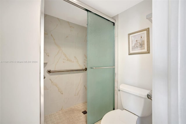 bathroom featuring an enclosed shower and toilet