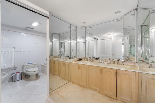 bathroom featuring vanity, toilet, tile walls, and a bidet