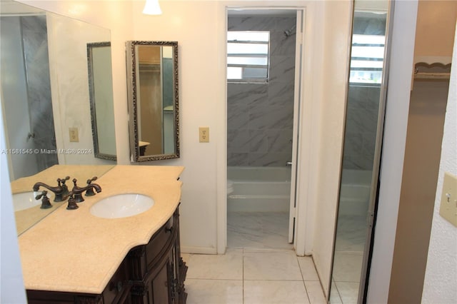 bathroom featuring vanity and tiled shower / bath