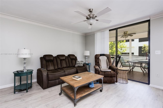 living area with light wood finished floors, ornamental molding, a ceiling fan, and baseboards