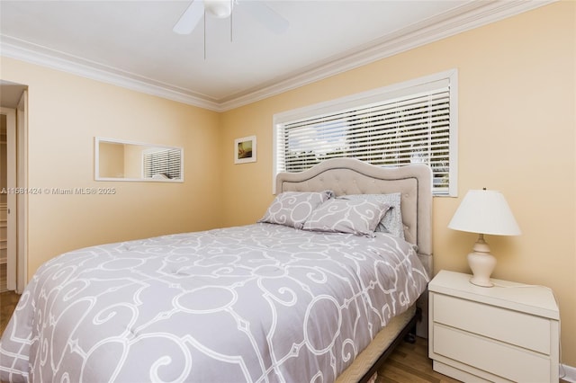 bedroom featuring a ceiling fan, crown molding, and wood finished floors