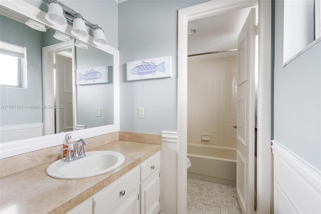 full bathroom featuring tub / shower combination, vanity, and toilet