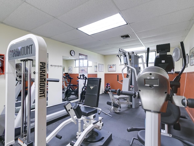 exercise room featuring a paneled ceiling and visible vents