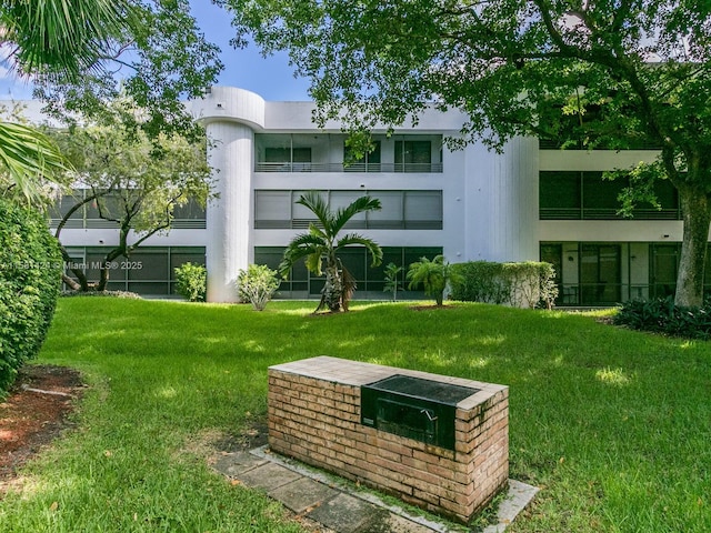 view of property's community with a lawn