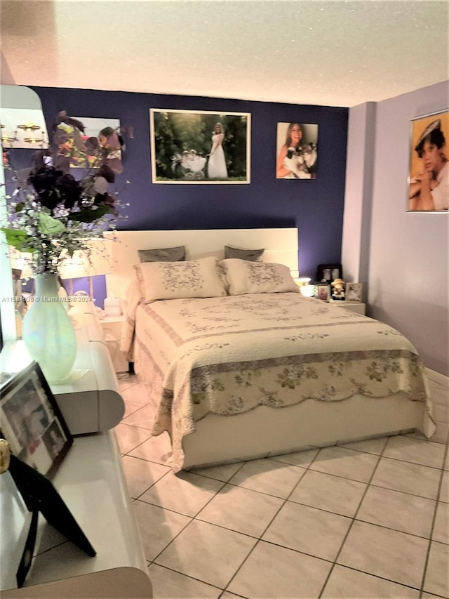 bedroom featuring tile floors and a textured ceiling