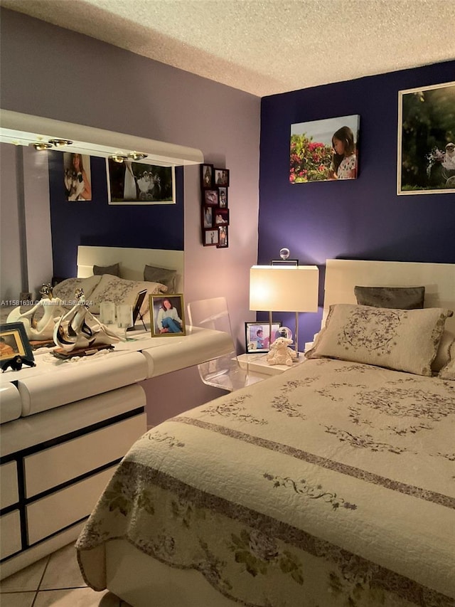 tiled bedroom featuring a textured ceiling