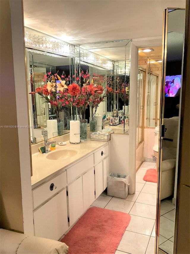 bathroom featuring tile floors, toilet, and large vanity