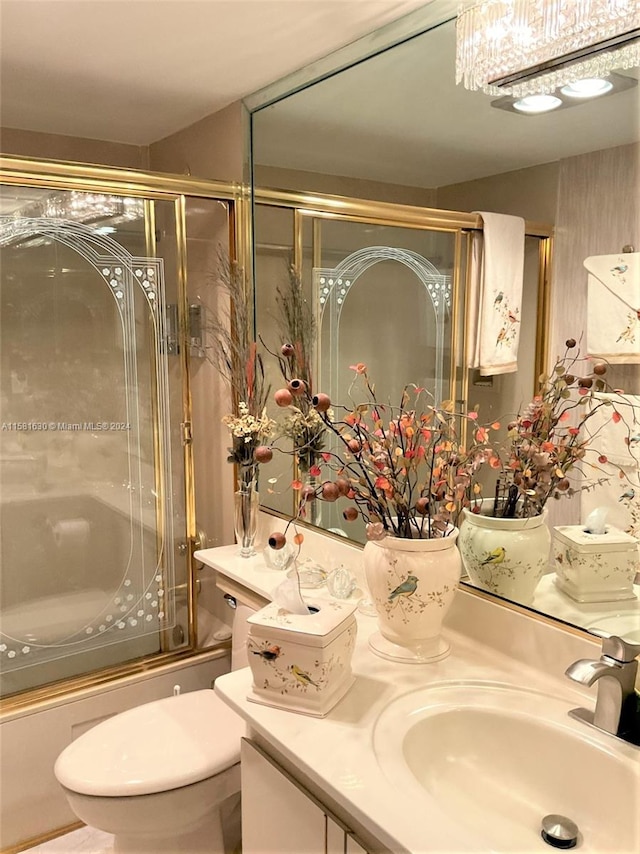 full bathroom with vanity, toilet, and combined bath / shower with glass door