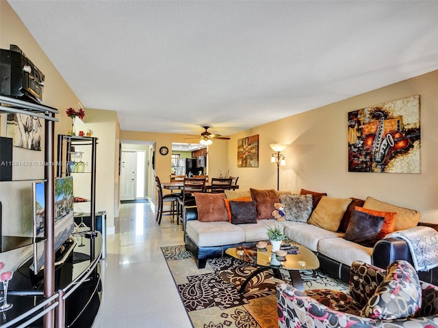 tiled living room with ceiling fan