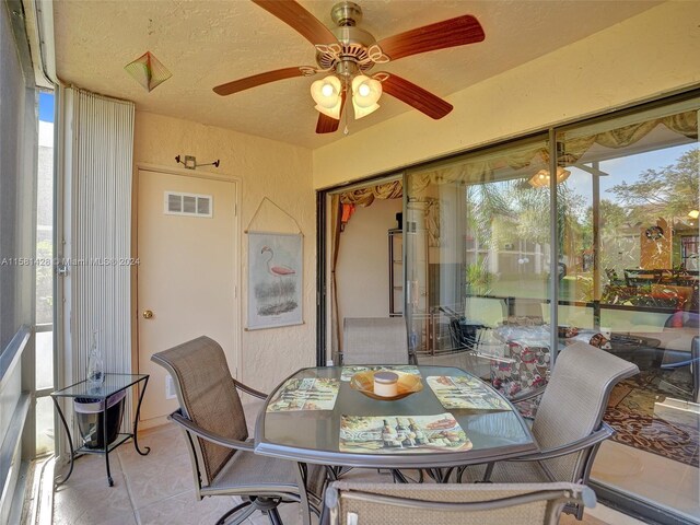 sunroom / solarium featuring ceiling fan and a healthy amount of sunlight