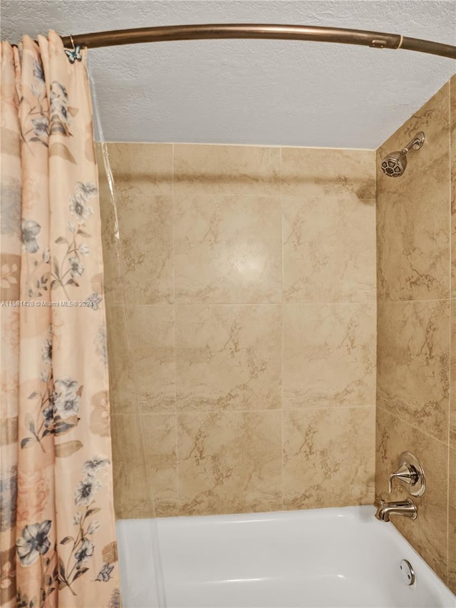 bathroom featuring a textured ceiling and shower / tub combo