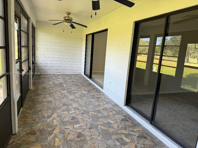 6114 SE Georgetown Pl, Hobe Sound, FL 33455 - unfurnished sunroom with a ceiling fan