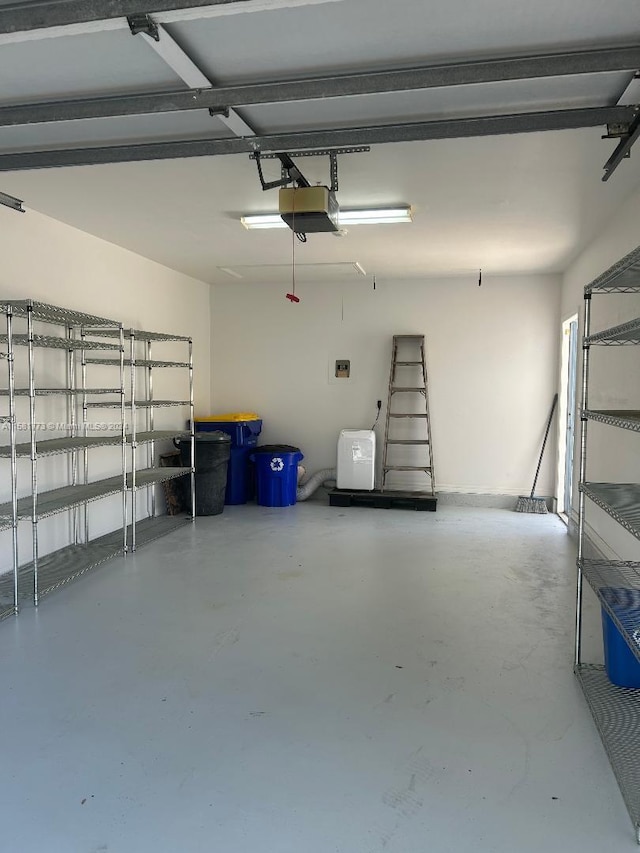 6114 SE Georgetown Pl, Hobe Sound, FL 33455 - garage featuring a garage door opener