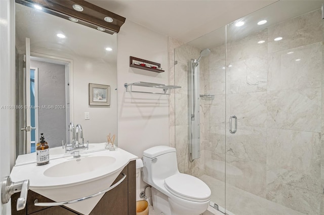 bathroom featuring vanity, an enclosed shower, and toilet