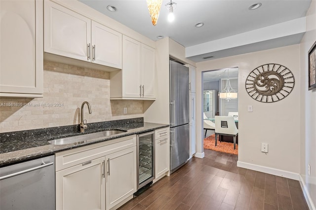 kitchen with sink, wine cooler, dark hardwood / wood-style floors, appliances with stainless steel finishes, and decorative light fixtures