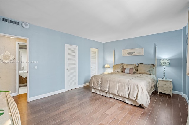 bedroom with dark hardwood / wood-style flooring