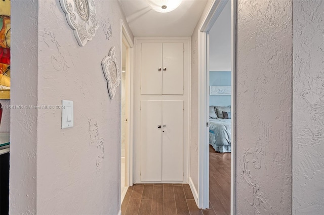 hallway with hardwood / wood-style floors