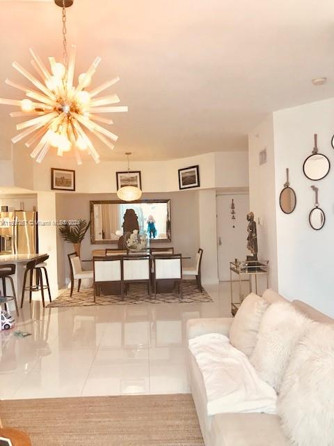 living room with a notable chandelier and tile flooring