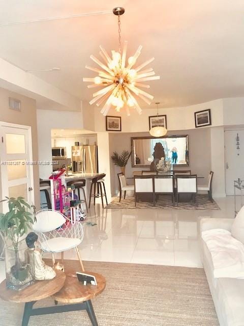 living room with tile floors and an inviting chandelier