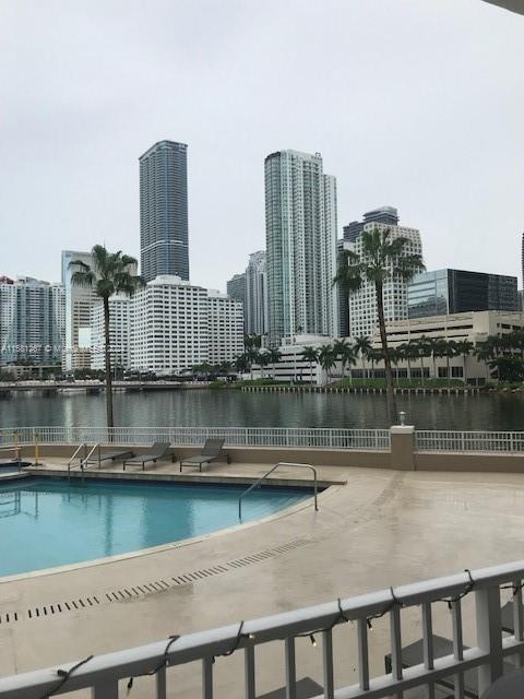 view of swimming pool featuring a water view