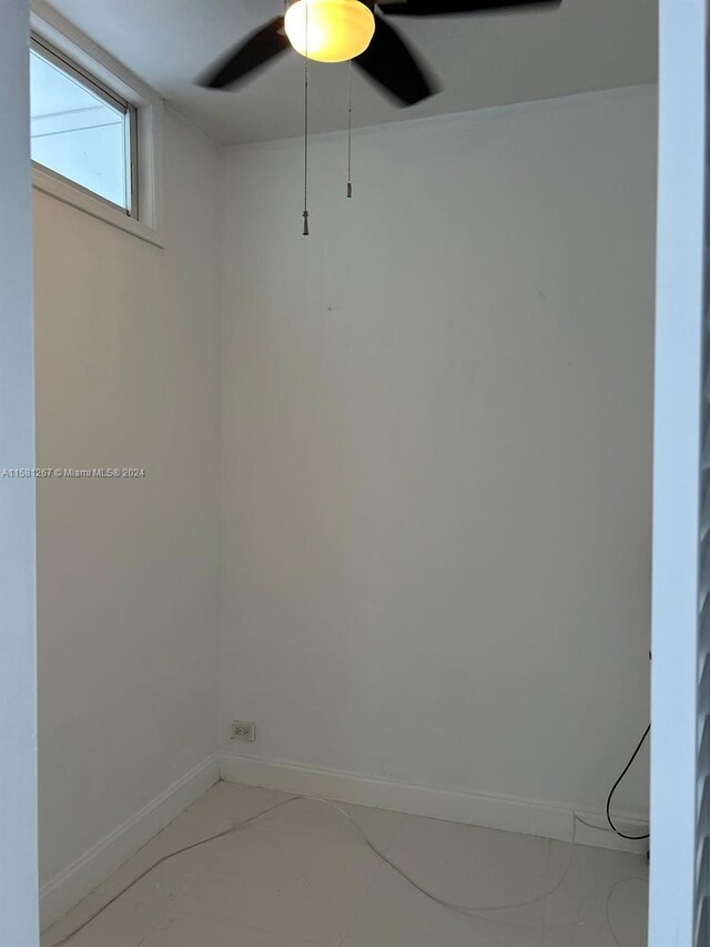 empty room featuring concrete floors and ceiling fan