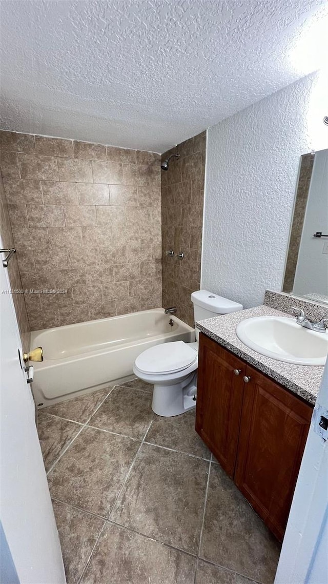 full bathroom featuring tiled shower / bath, tile flooring, and vanity