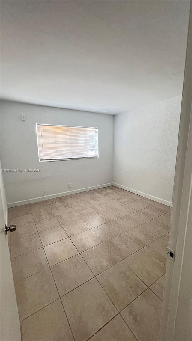 spare room featuring tile floors