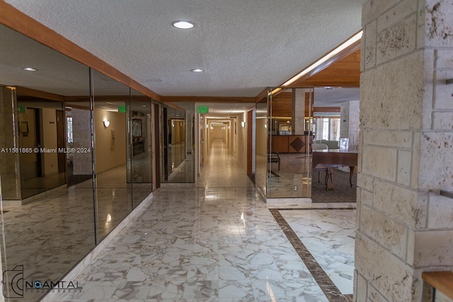 hallway featuring tile floors and a textured ceiling