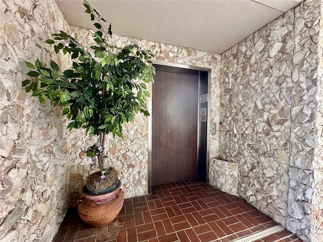 entrance to property featuring elevator