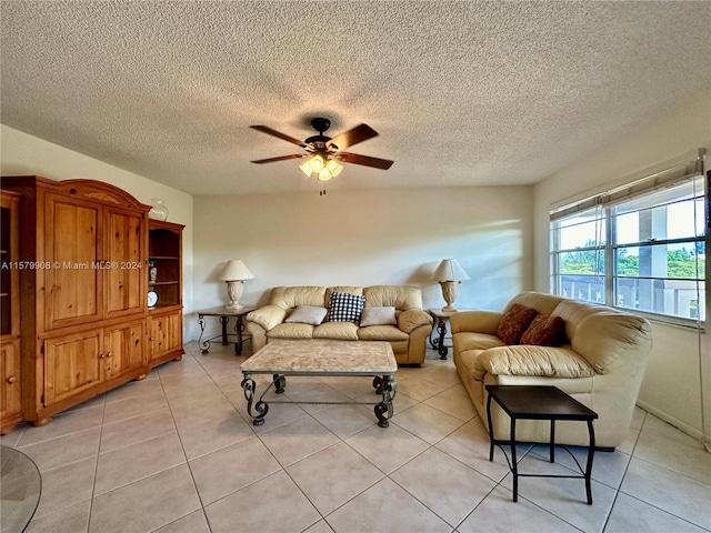 tiled living room with ceiling fan and a textured ceiling