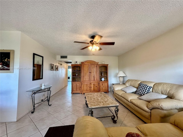 tiled living room featuring ceiling fan and a textured ceiling