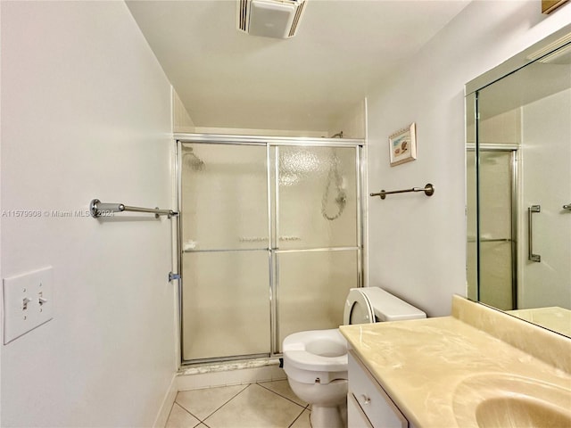 bathroom featuring tile floors, vanity with extensive cabinet space, an enclosed shower, and toilet