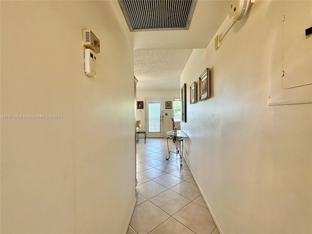 hall featuring light tile floors