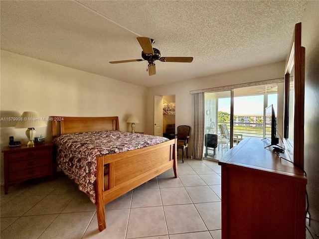 tiled bedroom featuring ceiling fan, access to outside, and a textured ceiling