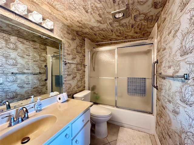 full bathroom featuring tile flooring, combined bath / shower with glass door, vanity, and toilet