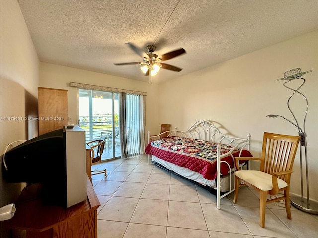 tiled bedroom featuring ceiling fan, access to exterior, and a textured ceiling