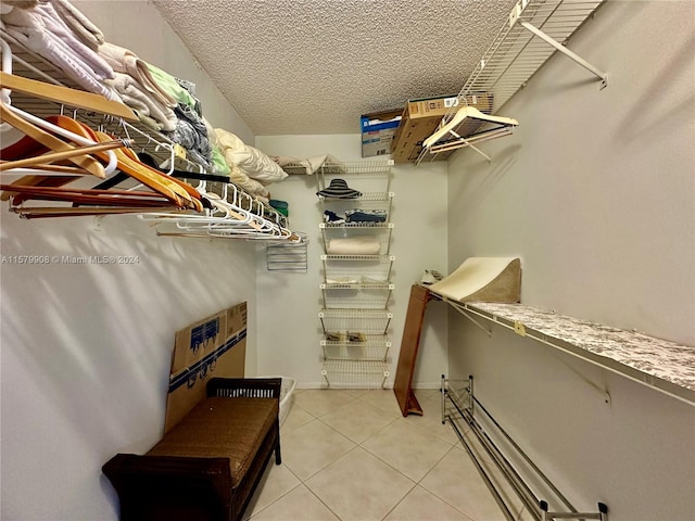 spacious closet with light tile floors